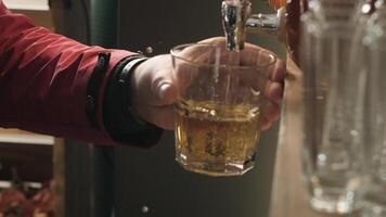 Man pouring from tap fresh juice into the glass in party video