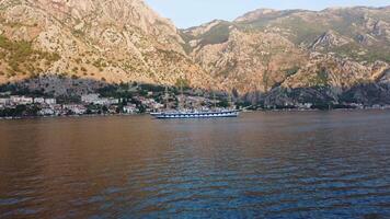 Low angle view near the water of the magnificent sailing ship in the Mediterranean sea in the Bay of Kotor with the mountains in the background video