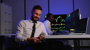 Smiling trader counting money after cryptocurrency market profits video
