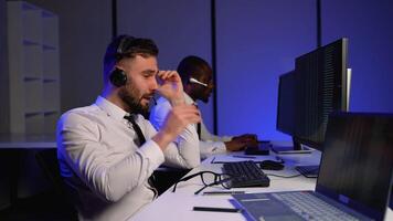 Tired call center operator working late at the office video