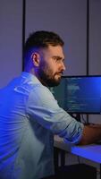 Cybersecurity analyst working on code and system monitoring video
