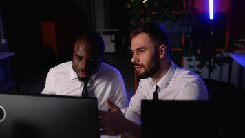 Two traders analyzing financial data on computer screens video