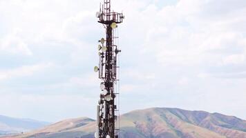 telecommunication tower in front of overcast sky and mountains on horizon 5 video