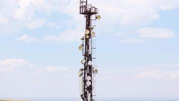 telecommunication tower in front of overcast sky and mountains on horizon 6 video