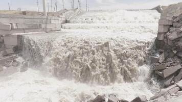Splashing White Water Cascading Over a Waterfall Edge of concrete water spillway... video