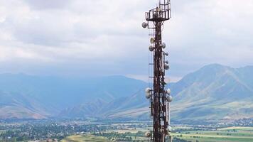 telecommunication tower in front of agricultural field and mountain range 7 video