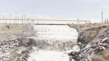 Splashing White Water Cascading Over a Waterfall Edge of concrete water spillway 2 video
