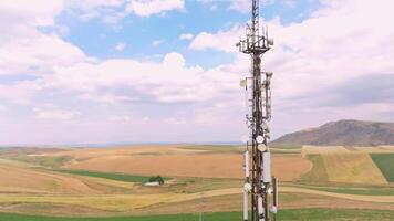 telecommunication tower in front of agricultural field and mountain range 2 video