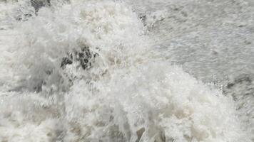 row of chute dentate blocks in water spillway channel slope slowing down splashing flow of water running down video