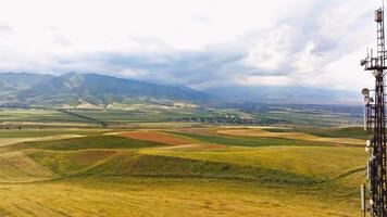 telecommunication tower in front of agricultural field and mountain range 3 video