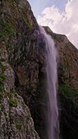 Small waterfall in the shadow of the cliff at sunny day 3 video