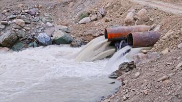 mountain river water flowing through steel pipes under temporary bridge video