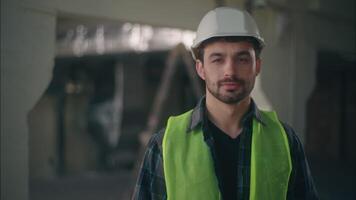 Caucasian builder man smiling looking at camera guy portrait male happy worker contractor in helmet engineer architect workman building industry construction foreman repairman professional inspector video
