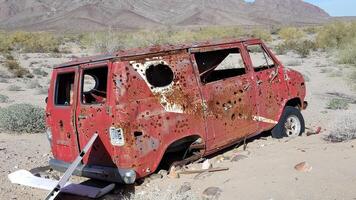 Old Rusty Red Van Abandoned in Southern California Desert with Windows Gone photo