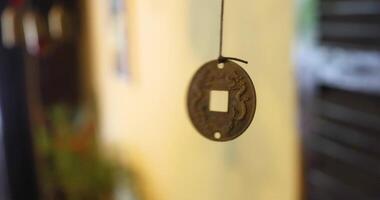 A Chinese lucky coin with a hole inside spins around its axis. video