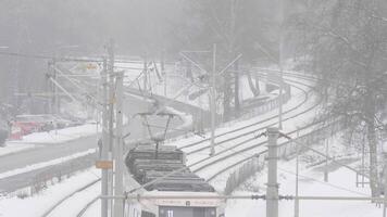 Tram departing in a winter foggy day with a lot of snow, High Angle View video