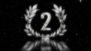 A gorgeous silver emblem of the second place ranking with a laurel wreath and a petal in the middle. video
