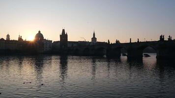 stunning sunset over the historic Charles Bridge and calm Vltava River in Prague video