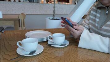 delightful coffee break while using a smartphone in a cozy, inviting setting video