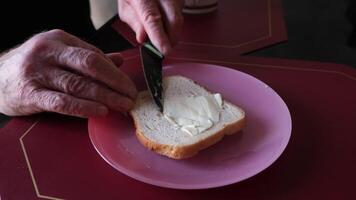 Generously spreading a creamy layer of tangy cream cheese on a slice of fresh video
