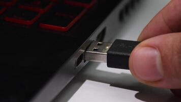 Connecting a USB cable to a computer, hand plugging device into USB port video