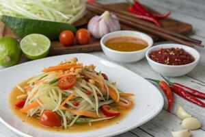 Delicious Papaya Salad with Fresh Vegetables and Spicy Dressing photo