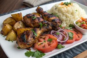 Grilled Chicken Drumsticks with Roasted Potatoes, Rice, and Fresh Salad photo