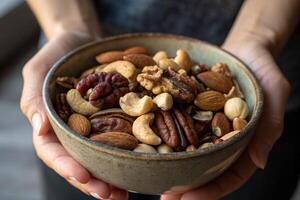 Assorted Mixed Nuts in a Bowl Held by Hands photo