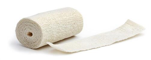 Rolled gauze bandage partially unrolled on white background photo