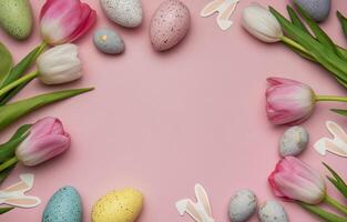 Easter eggs and tulips framing a pink background creating a festive spring atmosphere photo