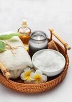 Magnesium flakes, essential oil, candle and towel creating relaxing spa atmosphere photo