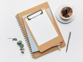 Clipboard, coffee, pen and notebook creating home office workspace photo