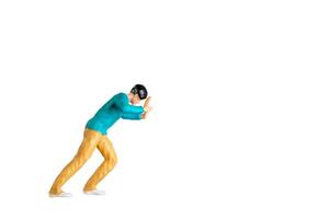Miniature Figurine Pushing Against Invisible Force isolated on white background with clipping path photo