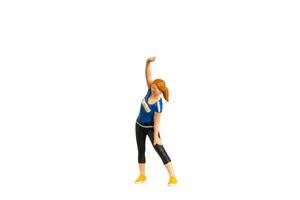 Figurine of a woman in workout attire performing a side stretch isolated on white background with clipping path photo