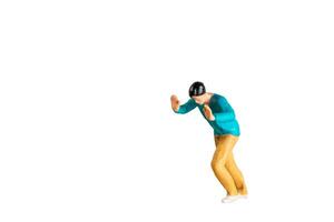 A Miniature Figurine Pushing Against Invisible Force isolated on white background with clipping path photo