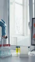 In a busy lab, a dedicated scientist in a lab coat examines a syringe of vivid blue liquid, surrounded by lab equipment and vials, highlighting the importance of their work in vaccine development video