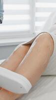 An experienced cosmetologist is performing an advanced skin treatment on a clients leg using cuttingedge technology, ensuring a comfortable atmosphere that promotes relaxation and wellness video