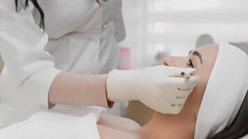A trained medical professional administers a precise botulinum injection to a client in a clinic, focusing on effectively reducing wrinkles during a cosmetic enhancement procedure video
