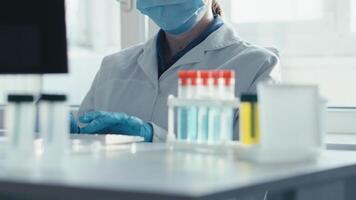 A dedicated scientist in protective gear prepares vaccine samples for analysis in a sterile environment, underscoring the importance of modern research in enhancing public health and safety video