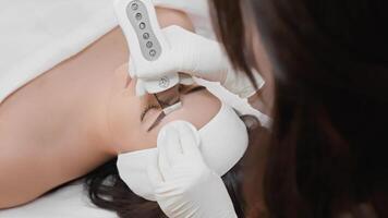An experienced cosmetologist uses advanced technology in a modern clinic to provide therapeutic skin treatments, focusing on improving skin health and appearance for optimal client satisfaction video