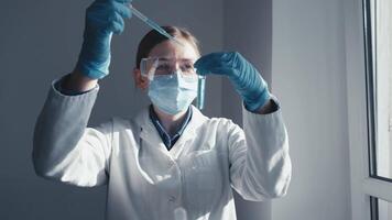 In a bright lab, a skilled scientist examines test tubes and samples, focusing on vital vaccine research and medical experiments that could greatly enhance global healthcare and peoples health video