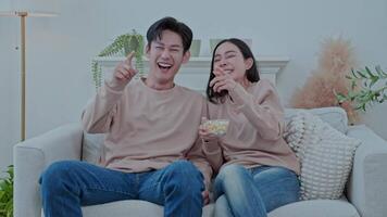 A couple is engrossed in watching TV and movie , excitedly enjoying the show they are watching. video