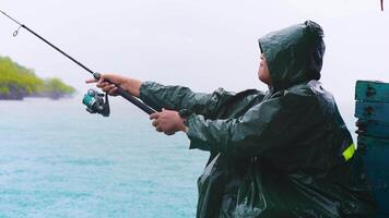 a man casting a line under the line in Slow motion. Peaceful Fishing on a Wet Day. Fishing Through the Raindrops video