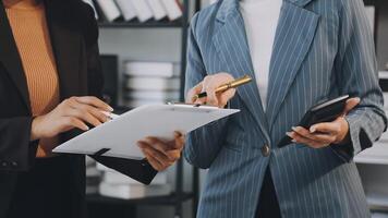 Two business people are holding a clipboard and a pen video