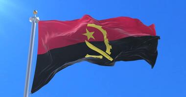 Angola flag waving at wind in slow with blue sky, loop video