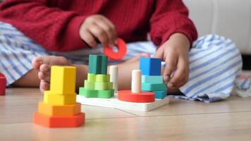 Child playing with colorful building blocks in a cozy indoor setting video