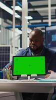 Vertical Factory engineer tripping while study assembly lines schematics, refining production layouts using green screen tablet. Experts outlining industrial plant configurations using mockup device, camera A video