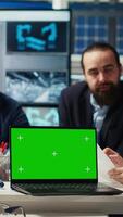 Vertical Factory engineers use green screen laptop to check PV materials parameters, improving solar panel durability. Researcher develop efficient sustainable energy solutions using mockup notebook, camera B video