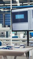 Vertical Research and development office in solar panels manufacturing plant used to study solar energy systems. Display on desk in empty photovoltaics factory used to improve efficiency and innovate video