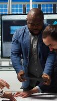Vertical Factory engineers study detailed schematics of solar panel assembly lines, refining production layouts using tablet. Industrial plant experts outlining configurations for new prototypes, camera A video